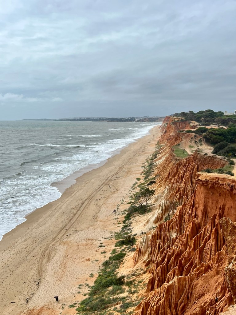 Red sandstone cliffs along a beach in Portugal