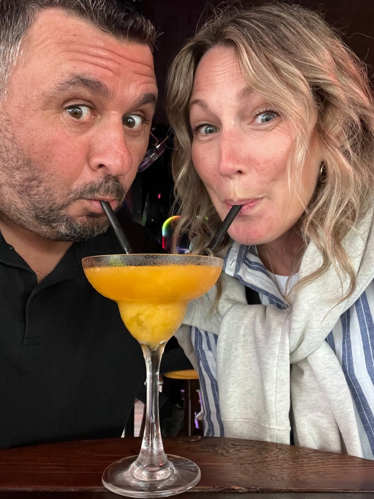 Couple sharing a drink with 2 straws