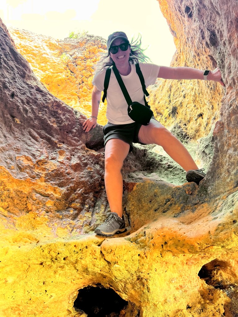 Climbing down the tunnel entrance at Praia Carvalho in the Algarve