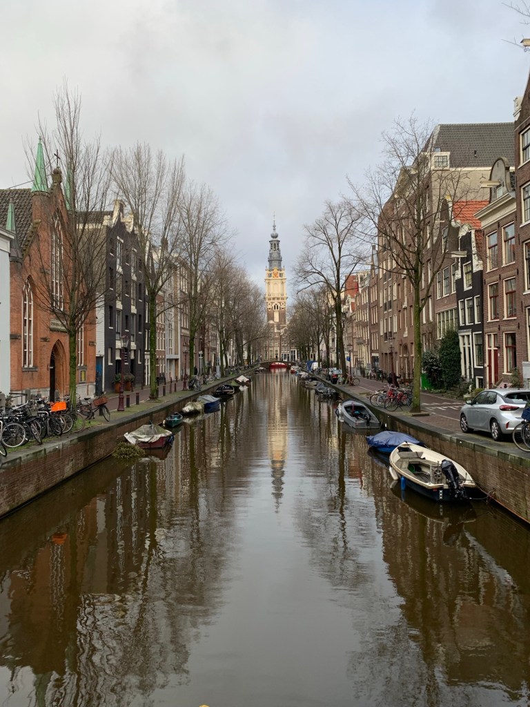 Canal with buildings along each side and boats in Amsterdam