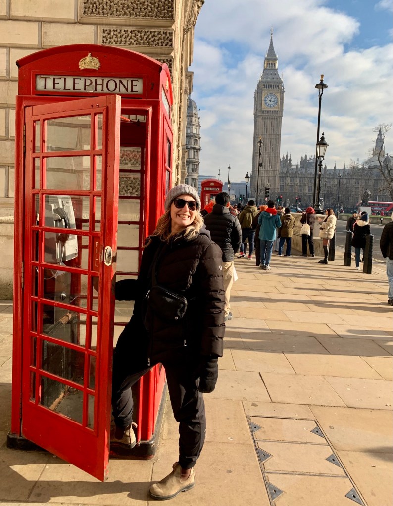 Red telephone booth on the streets of London with Big Ben in the background