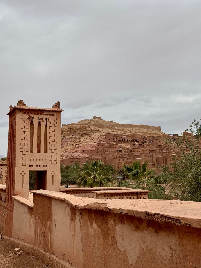 Earthen constructed wall and tower with historic site in background