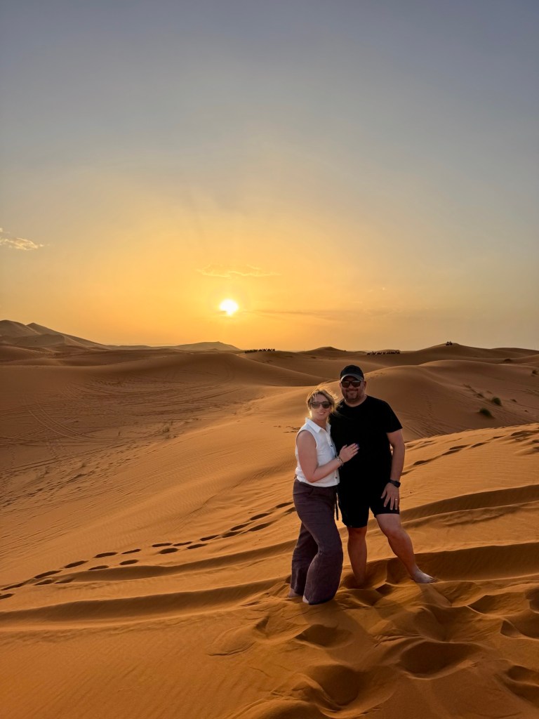 Couple posing in the desert at sunset