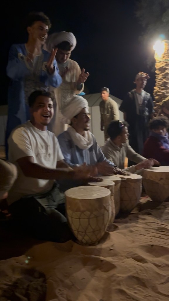 Group of men playing drums and singing