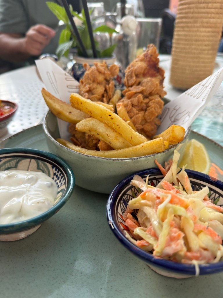 Bowl of fish and chis with fries and dressing